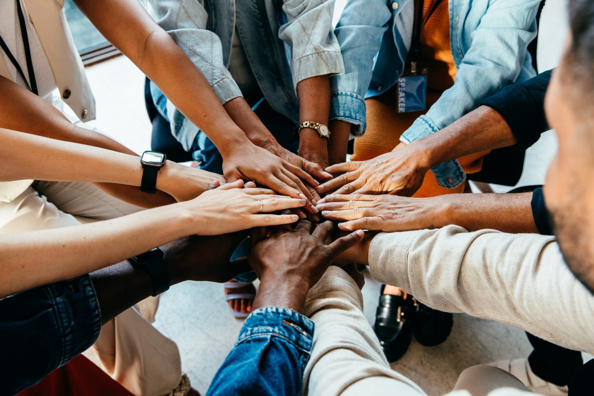 Diverse hands united in a circle.
