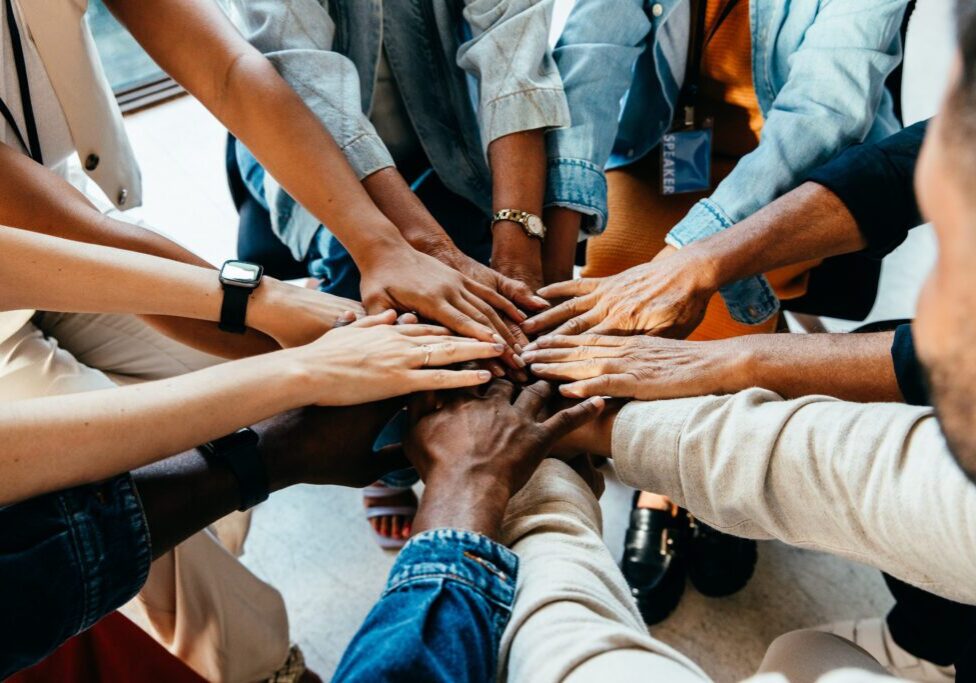 Diverse hands united in a circle.